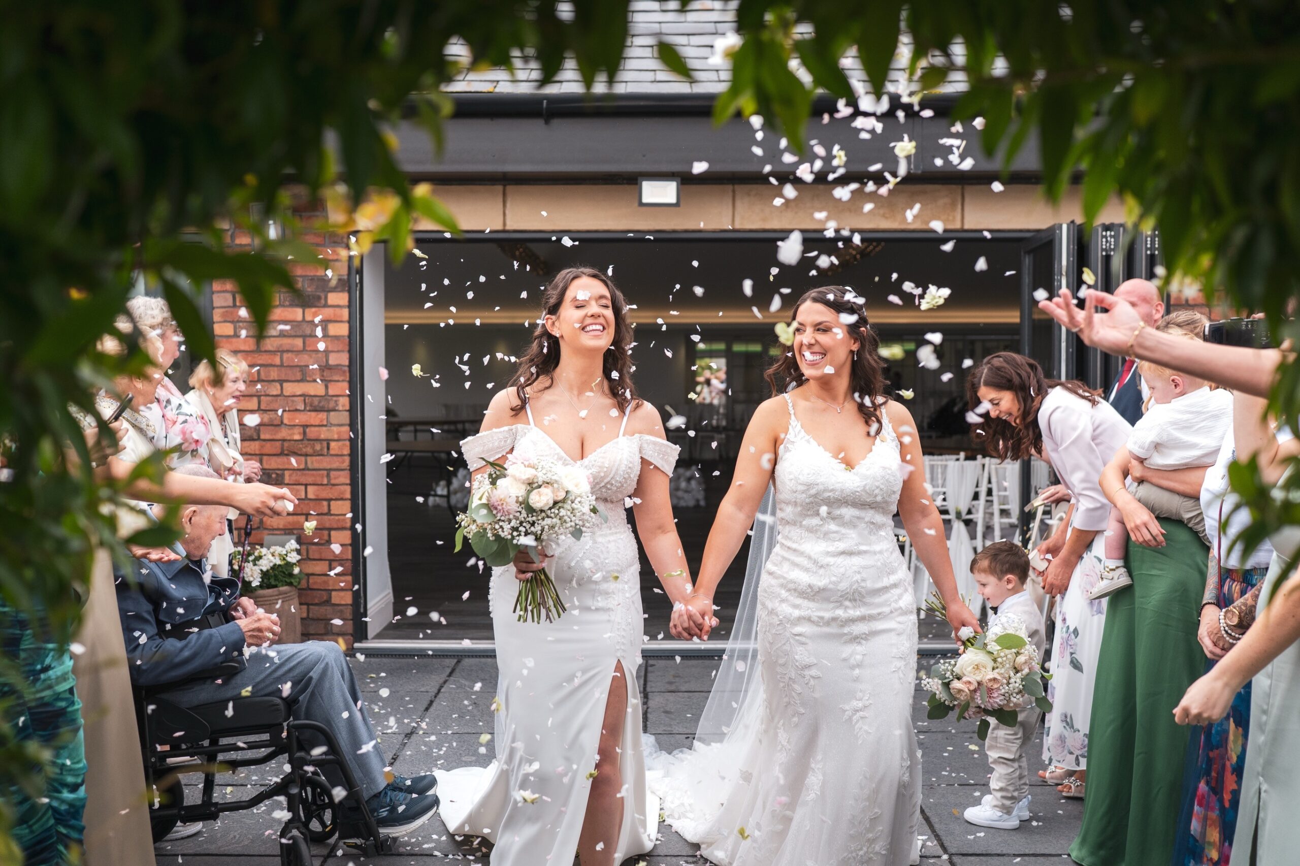 Two brides in wedding gowns with confetti Halem