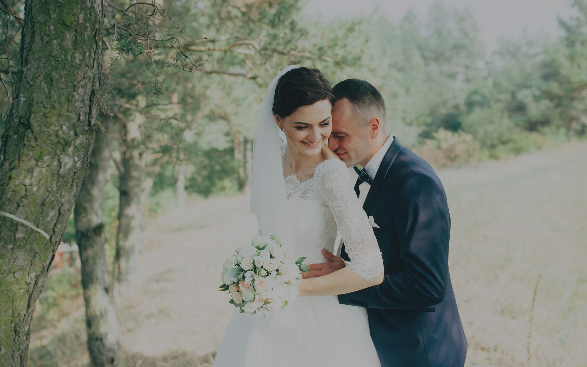 Bride and groom posing in woodland setting Halem